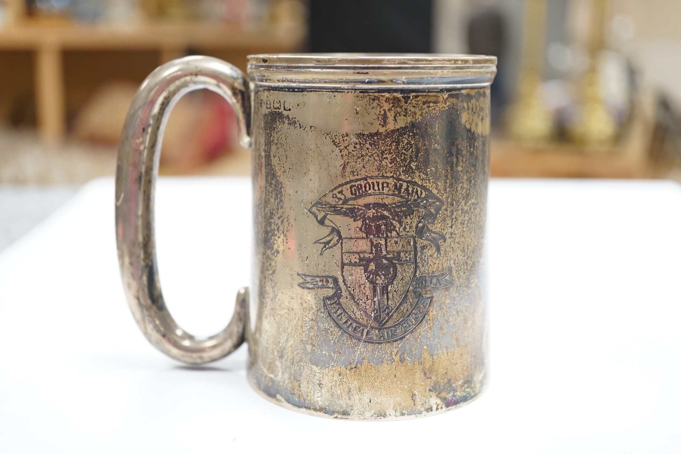 An RAF silver mug, and framed drawing of a map of Belgium and surrounding countries relating to 83rd Group Main HQ, Tactical Air Force 1944-45 together with four WWII medals in the original card, issue box; the Defence M